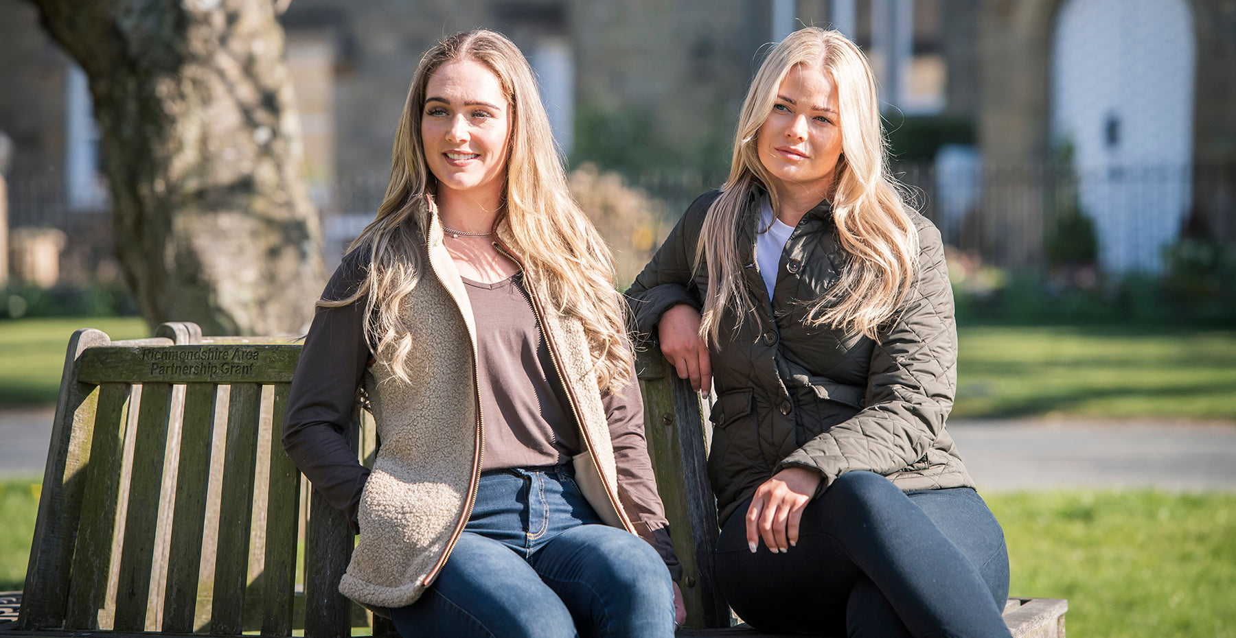 Two women wearing country gilets and jackets