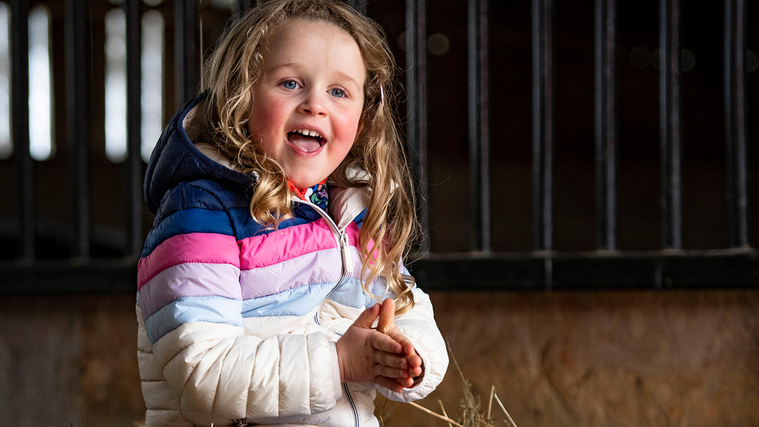 Girl wearing a Joules coat