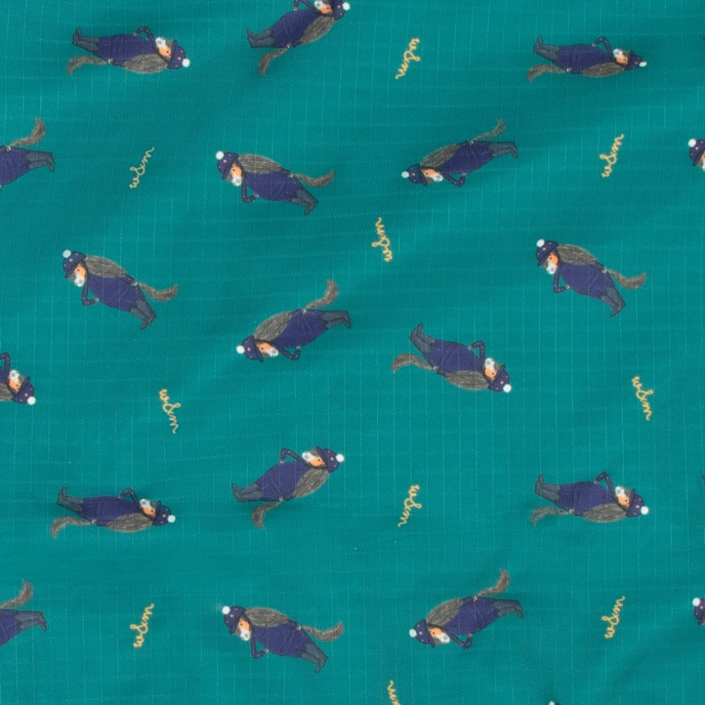 A close-up of teal fabric with a repeating print of cartoon horses