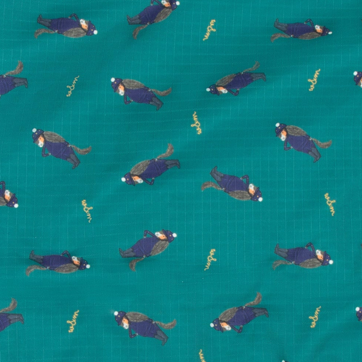 A close-up of teal fabric with a repeating print of cartoon horses
