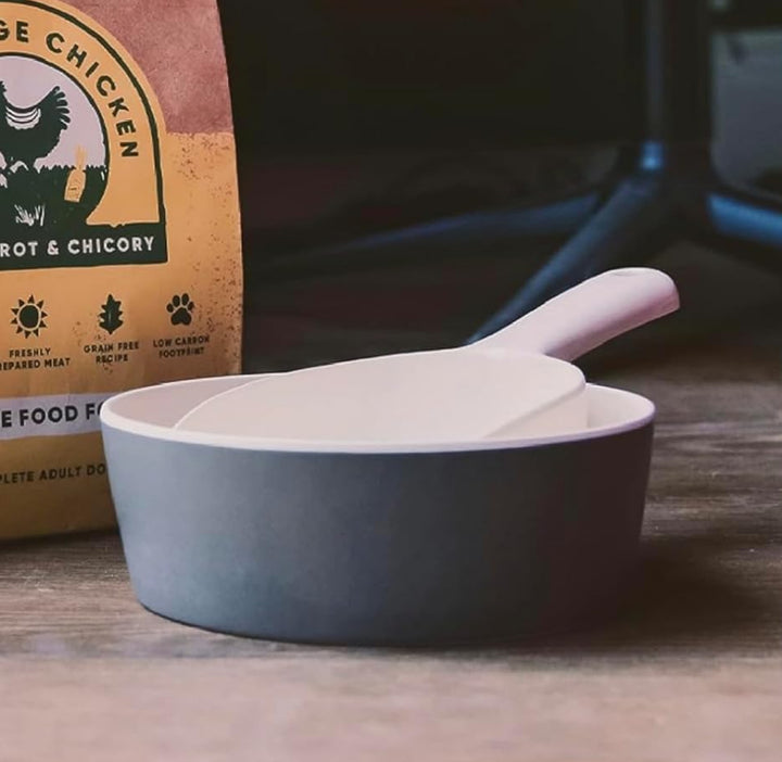 Beco free range chicken food packaging on a wooden surface with a bowl of food.