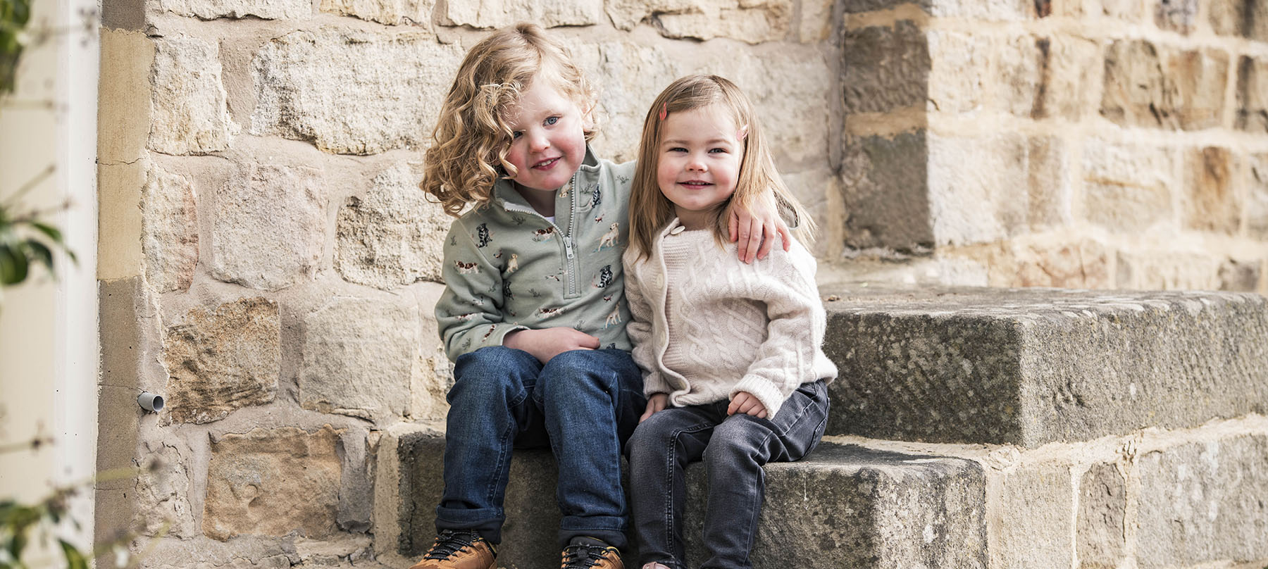 Two kids wearing The Little Stamford Company clothing