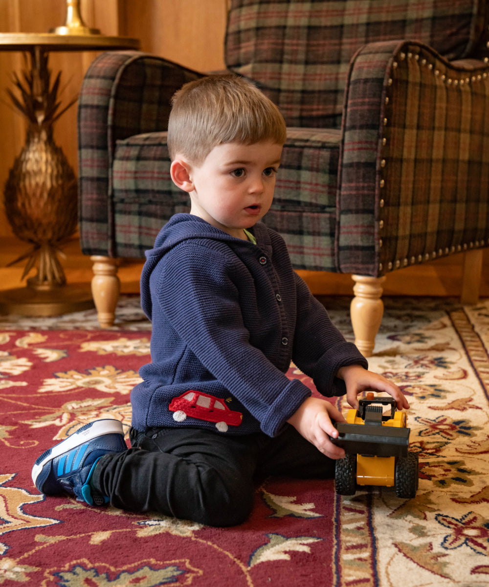 Boy playing with truck on the floor