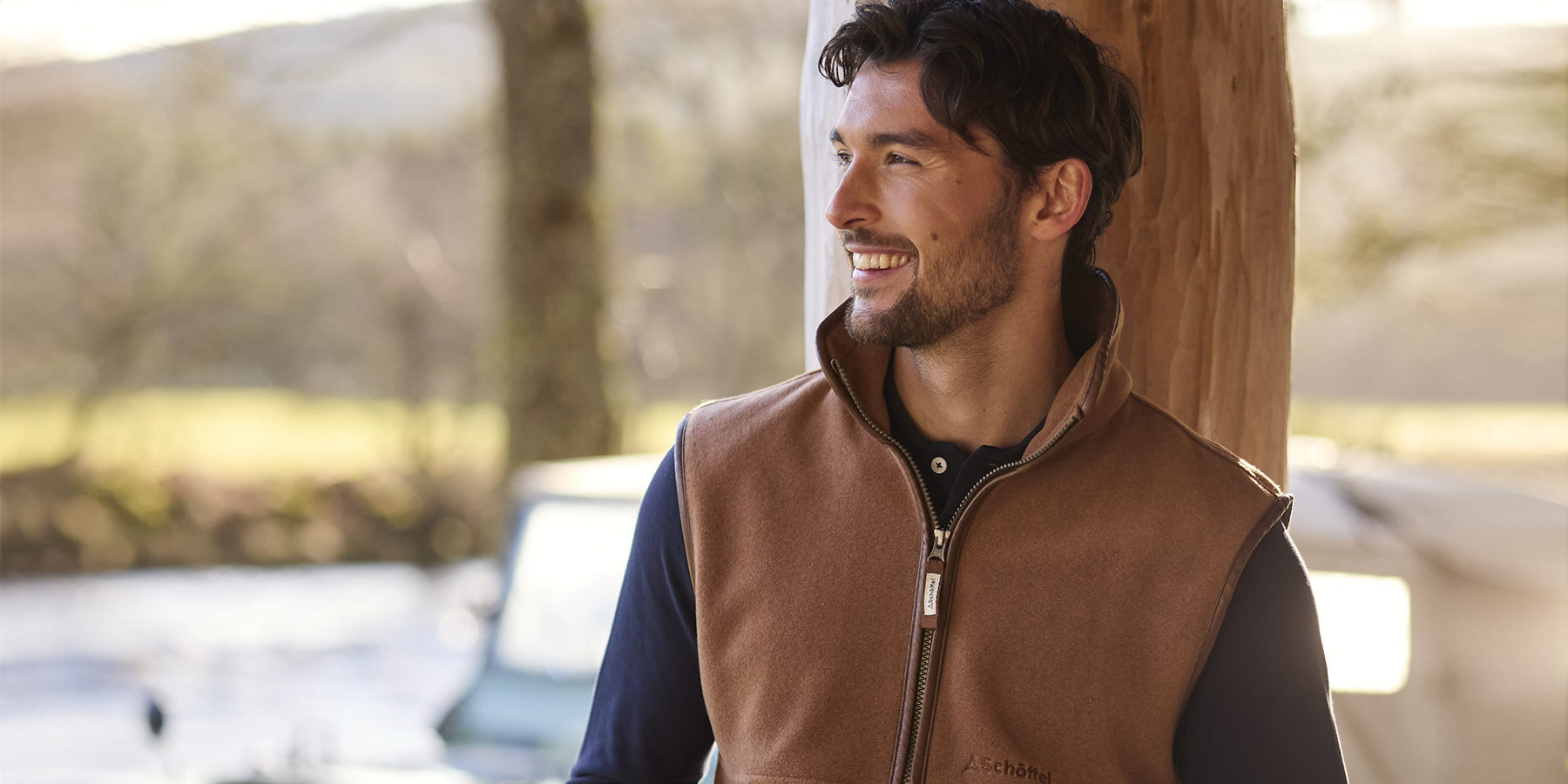 Man leaning against a tree wearing Schoffel clothing