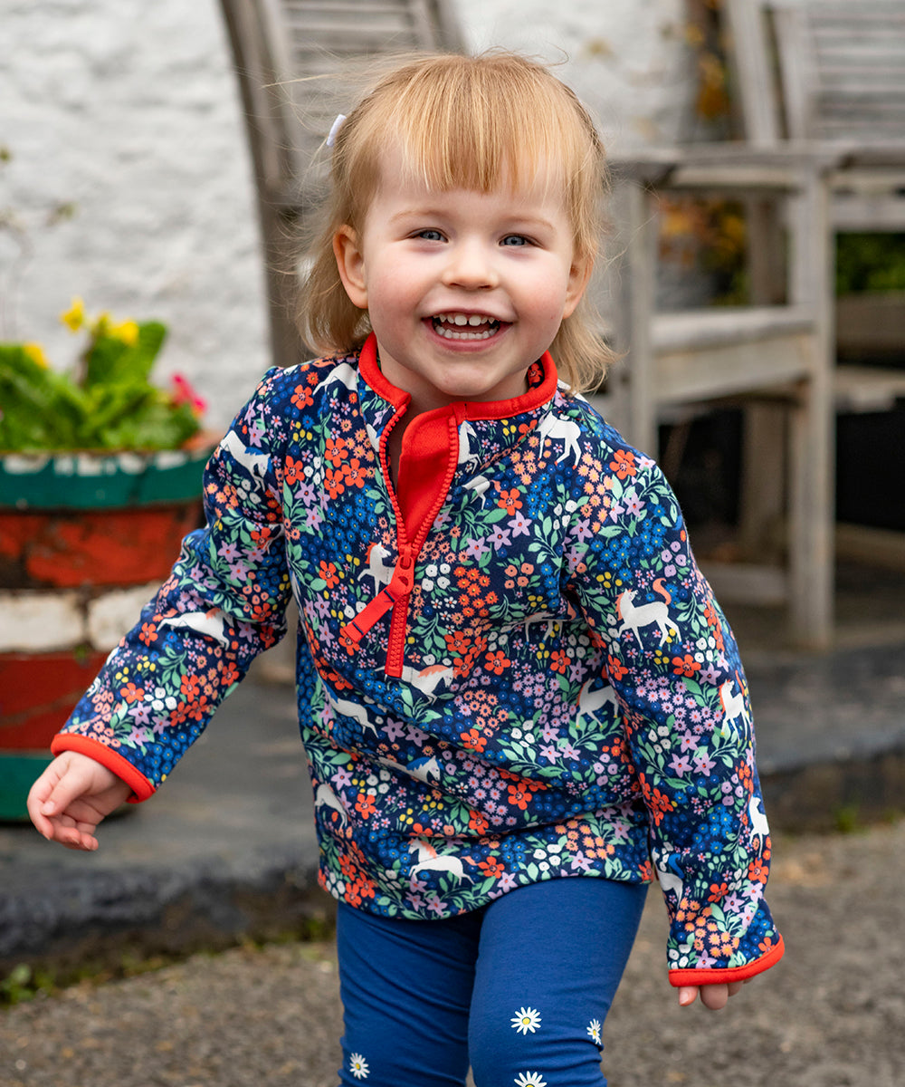 A little girl running outside