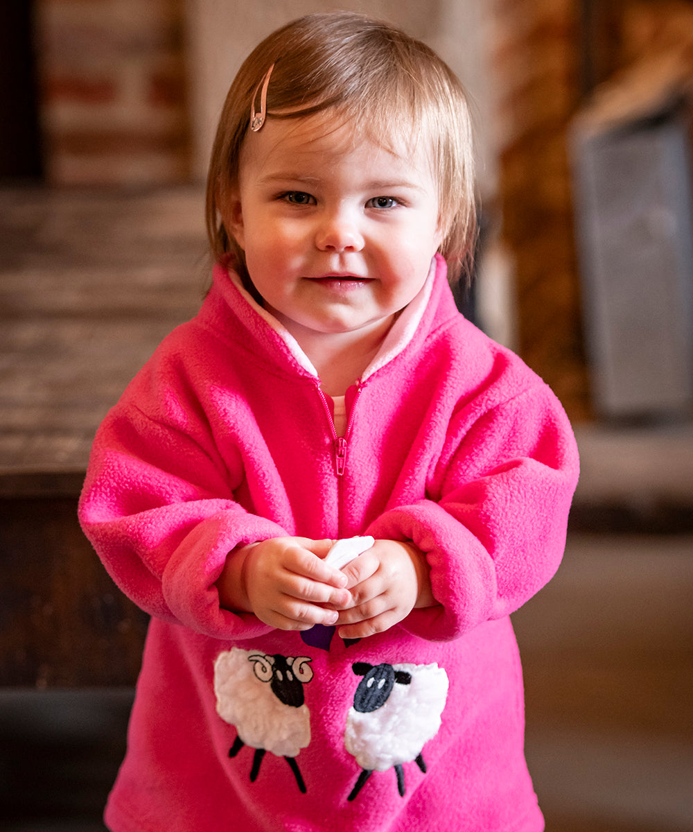 Girl wearing a fleece with sheep on it