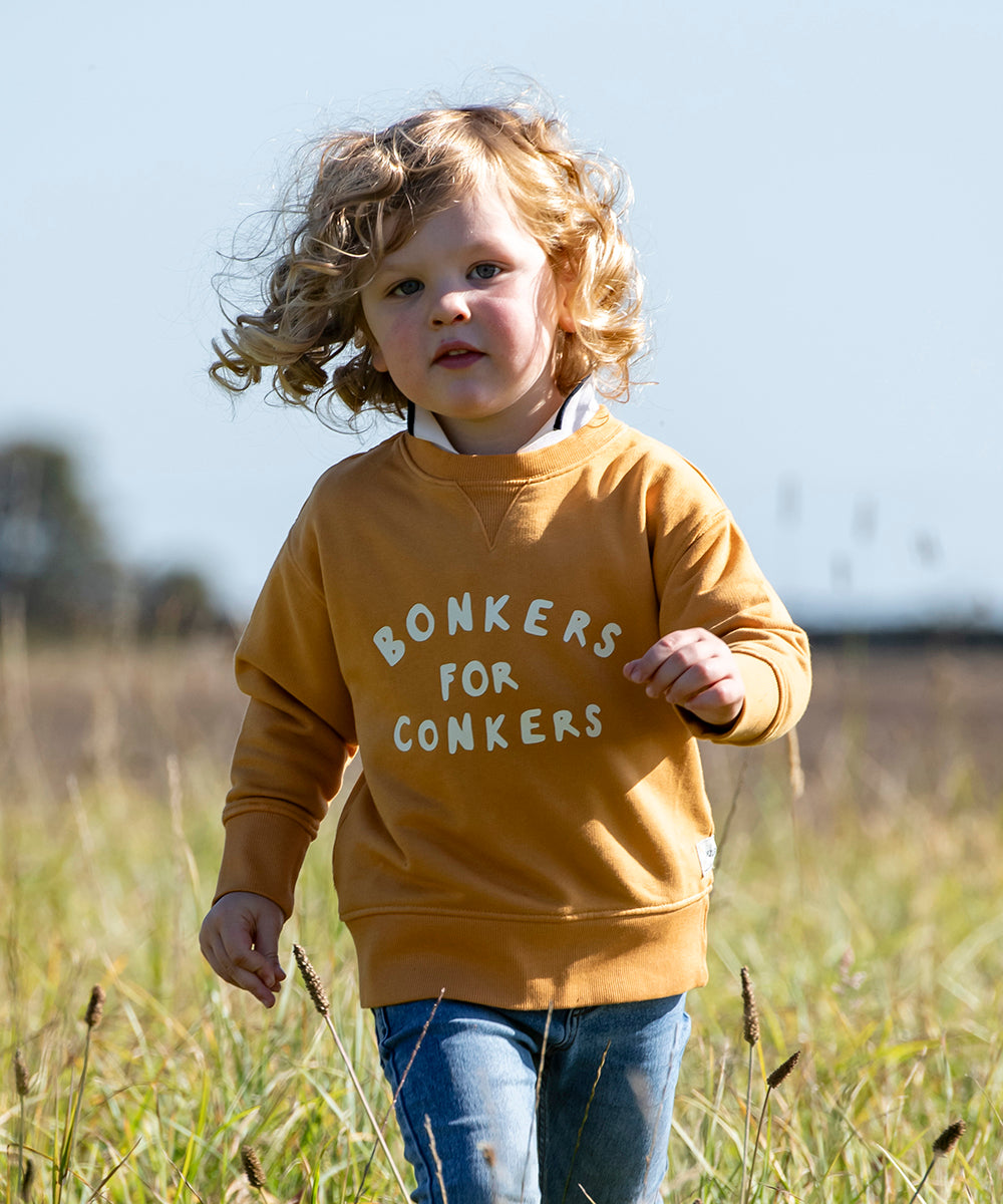 Boy running through a field