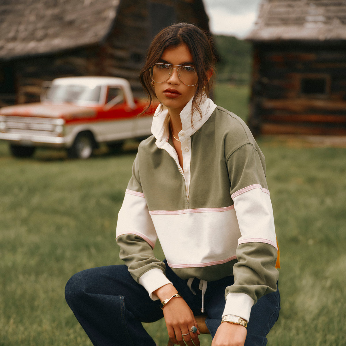 Woman sat in a field wearing new Joules clothing
