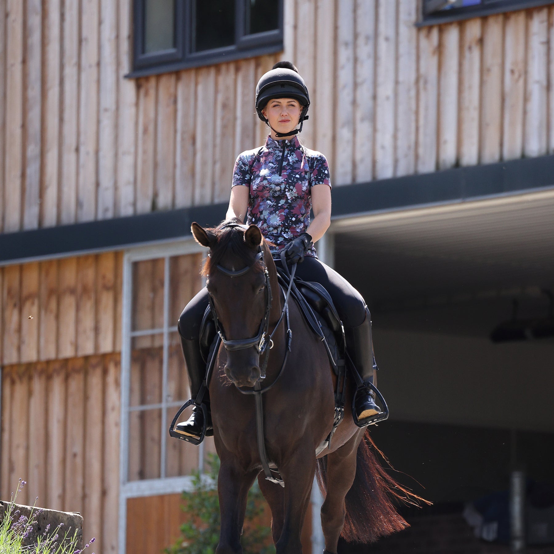Woman riding a horse wearing Aubrion clothing