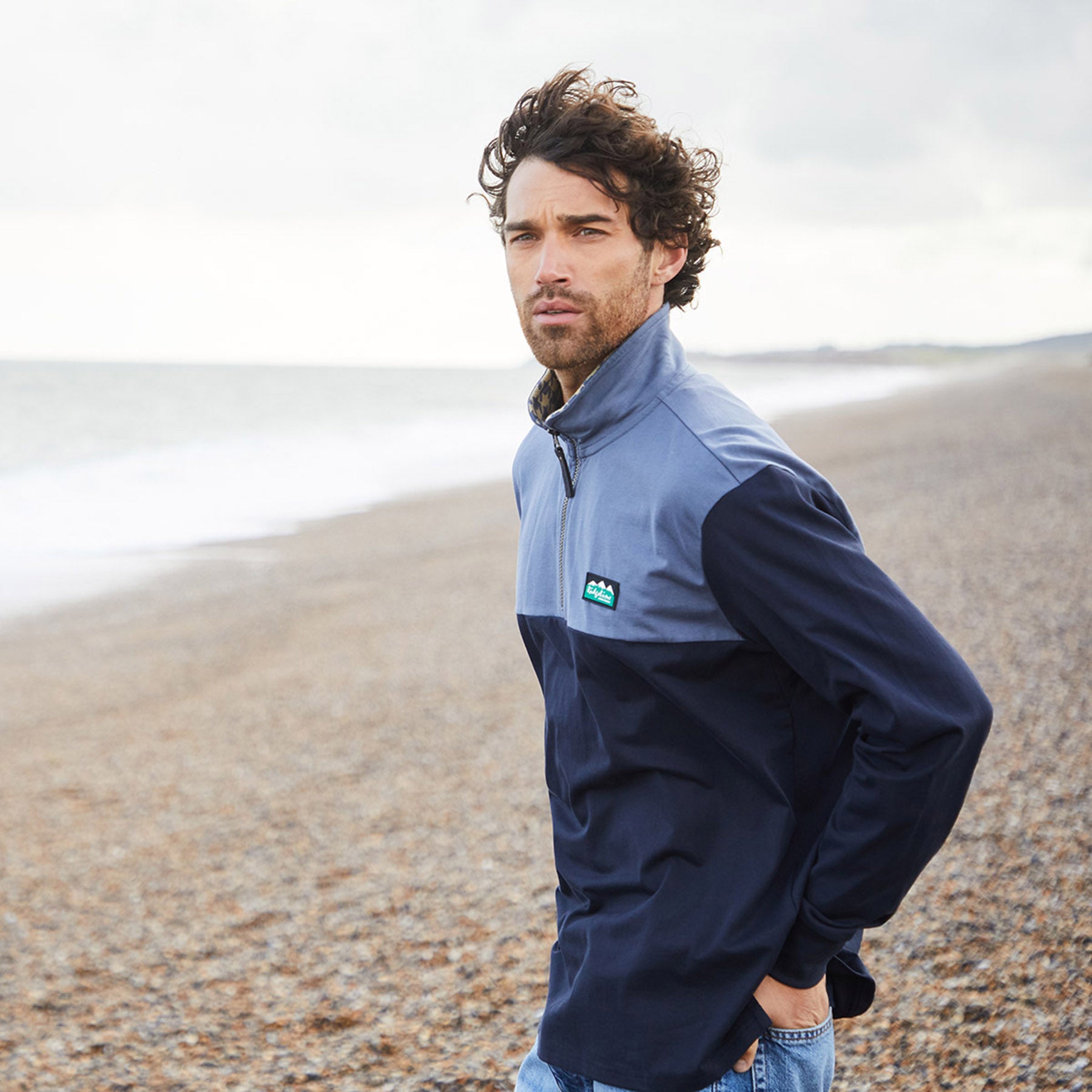 Man on a beach in Ridgeline clothing