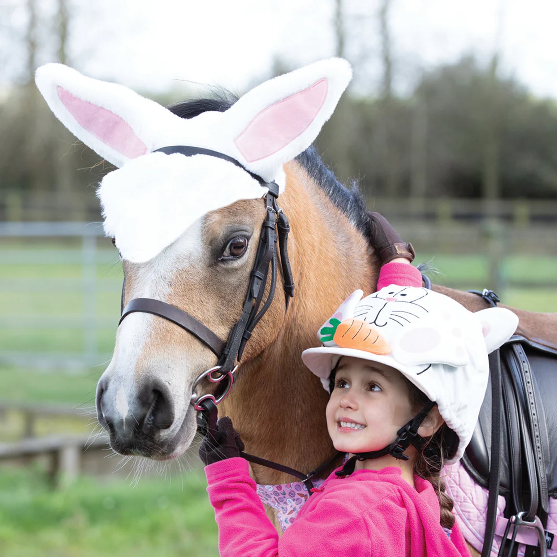 Girl with pony with Easter bunny ears and riding hat cover