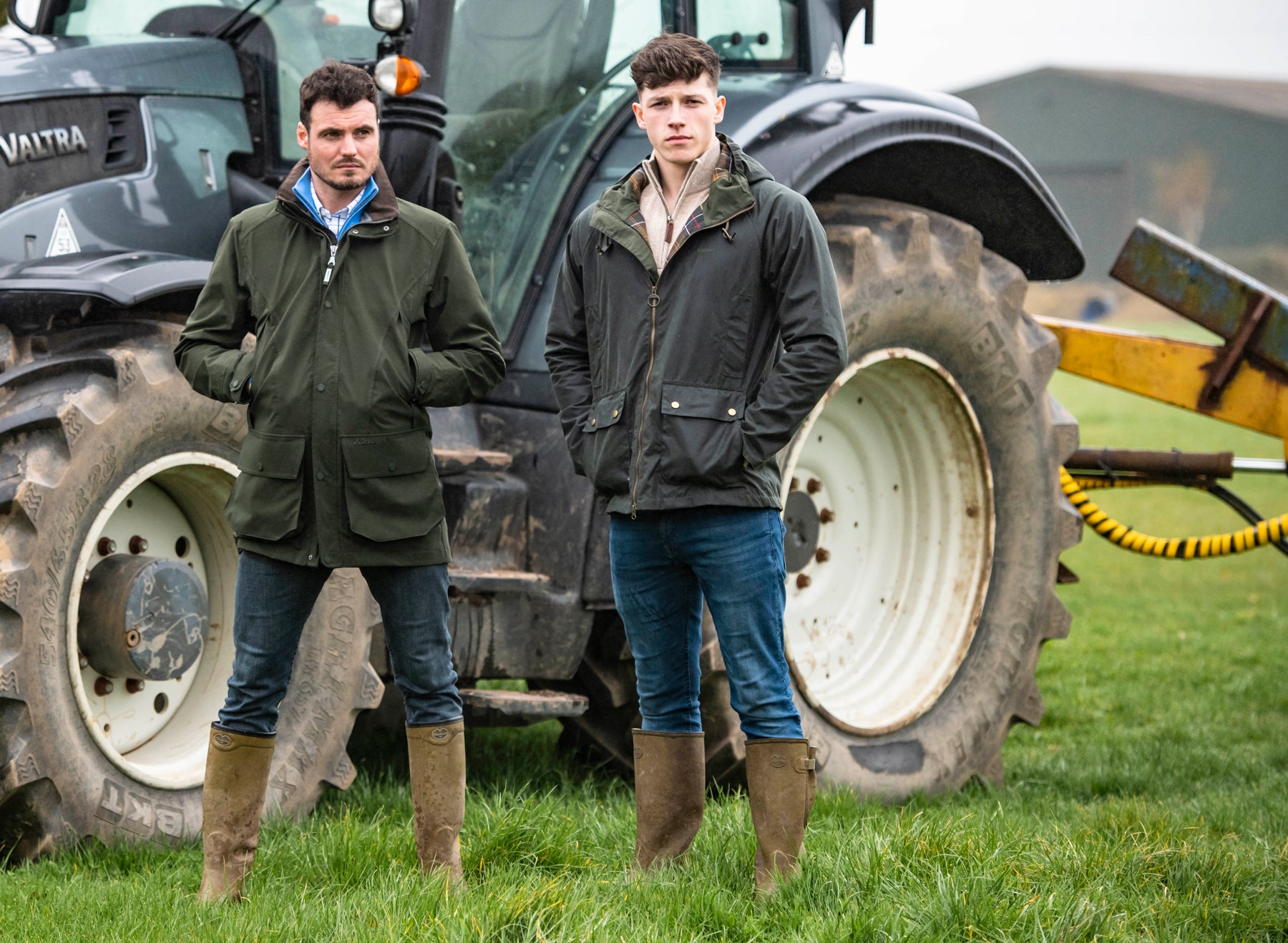 Two men standing by a tractor
