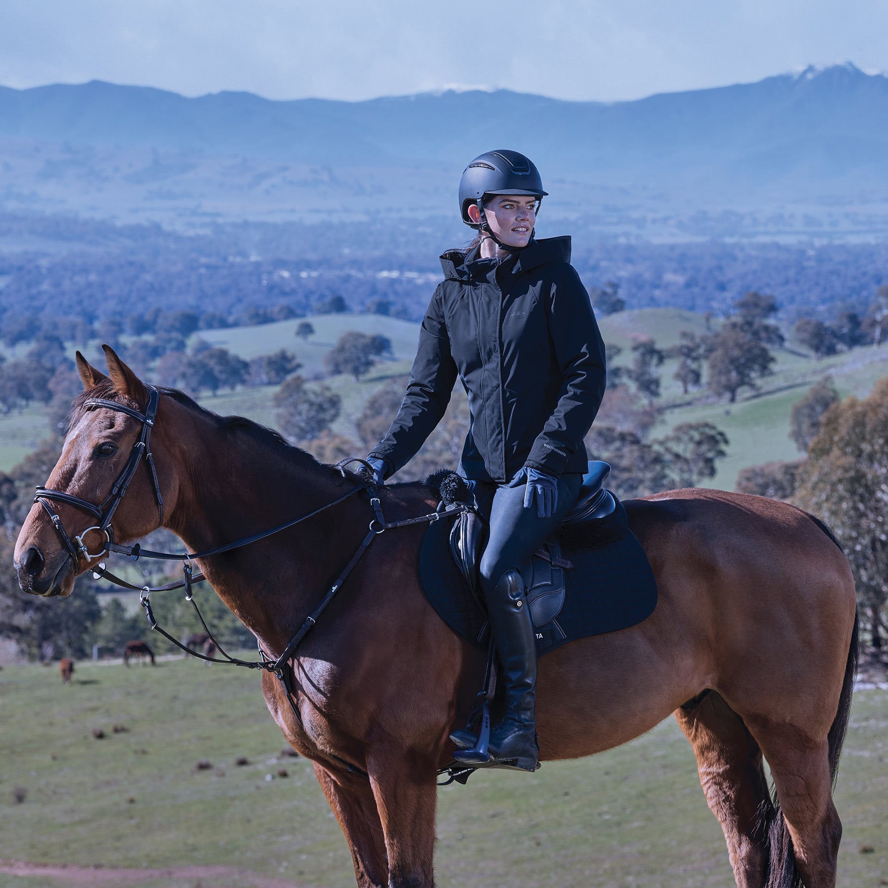 Woman on horse wearing the Weatherbeeta Protect Jacket