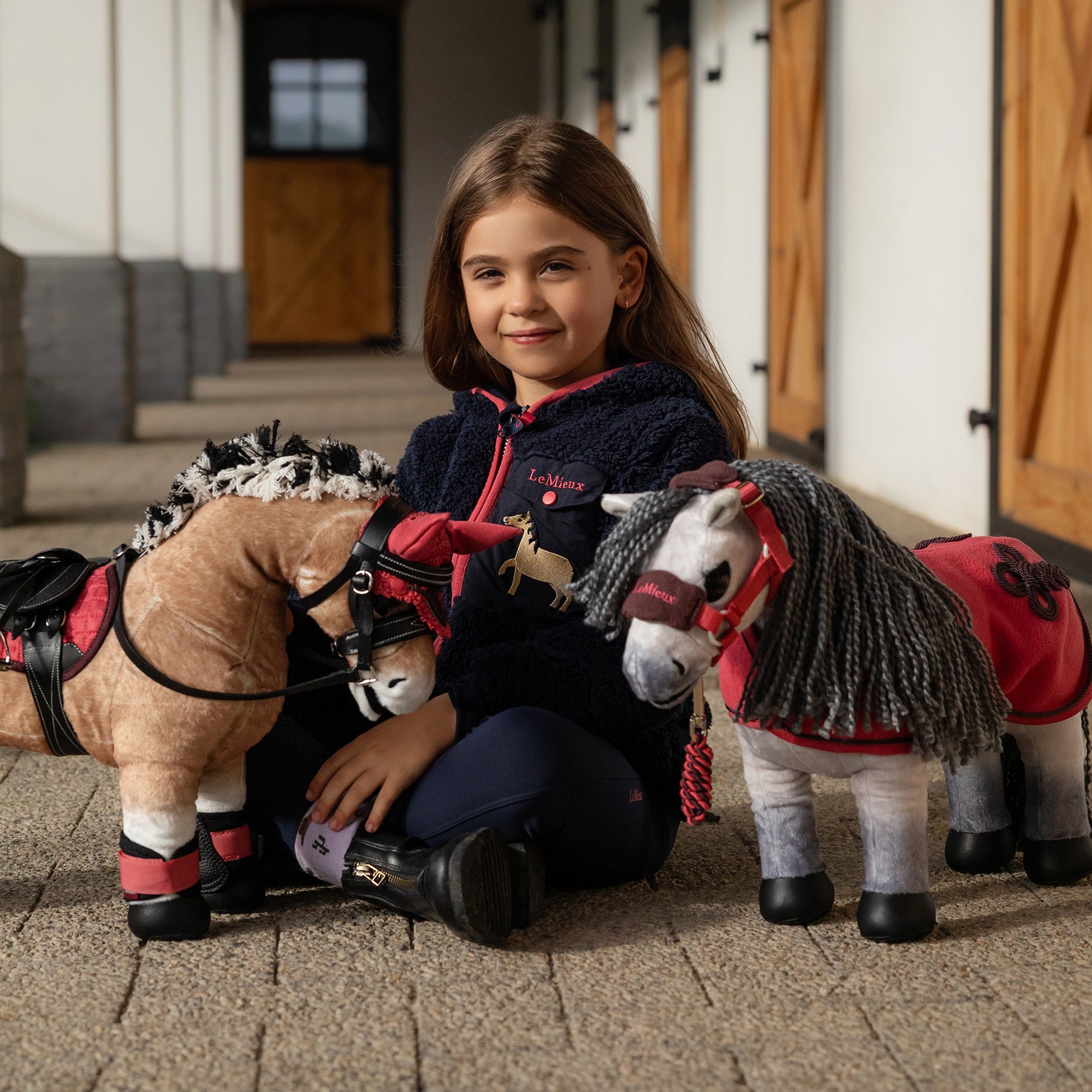 Little girl with LeMieux ponies & accessories