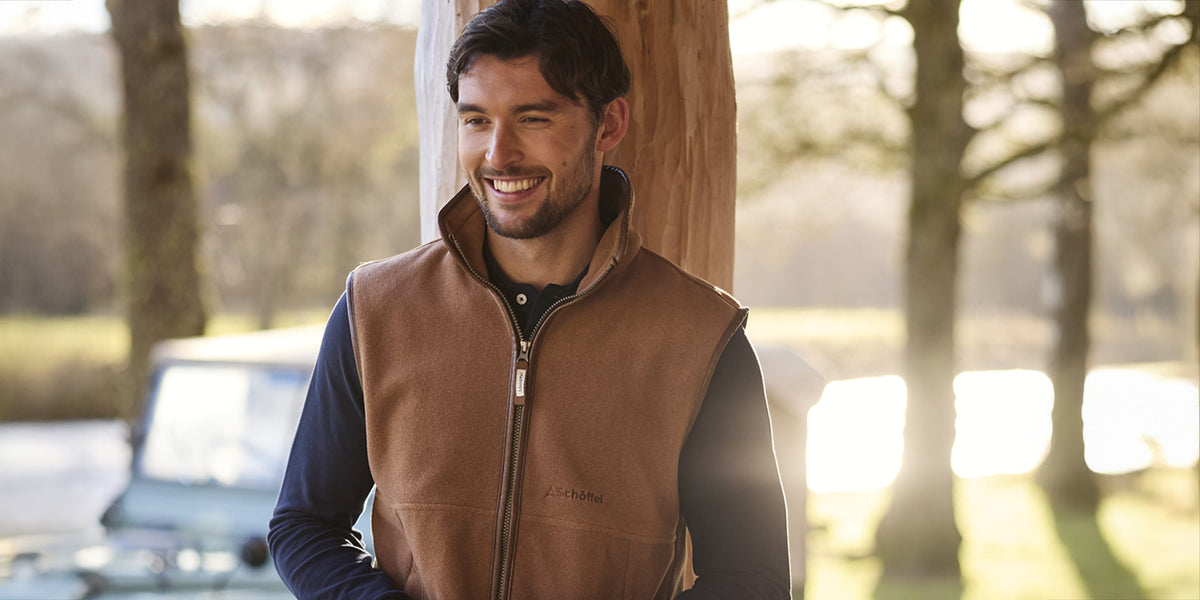 Man leaning against a tree wearing a new Schoffel gilet