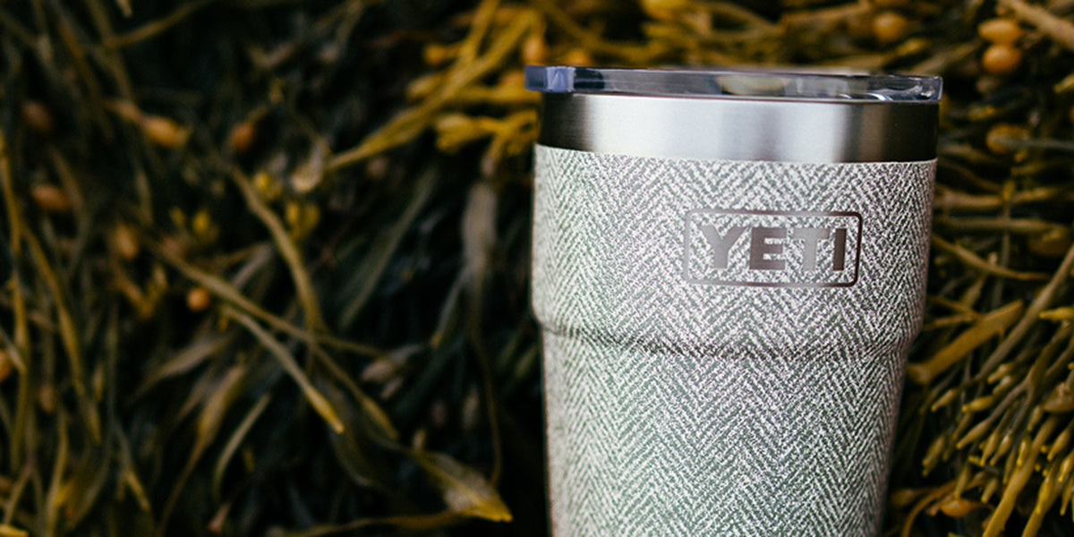 A Yeti tumbler lying in the grass