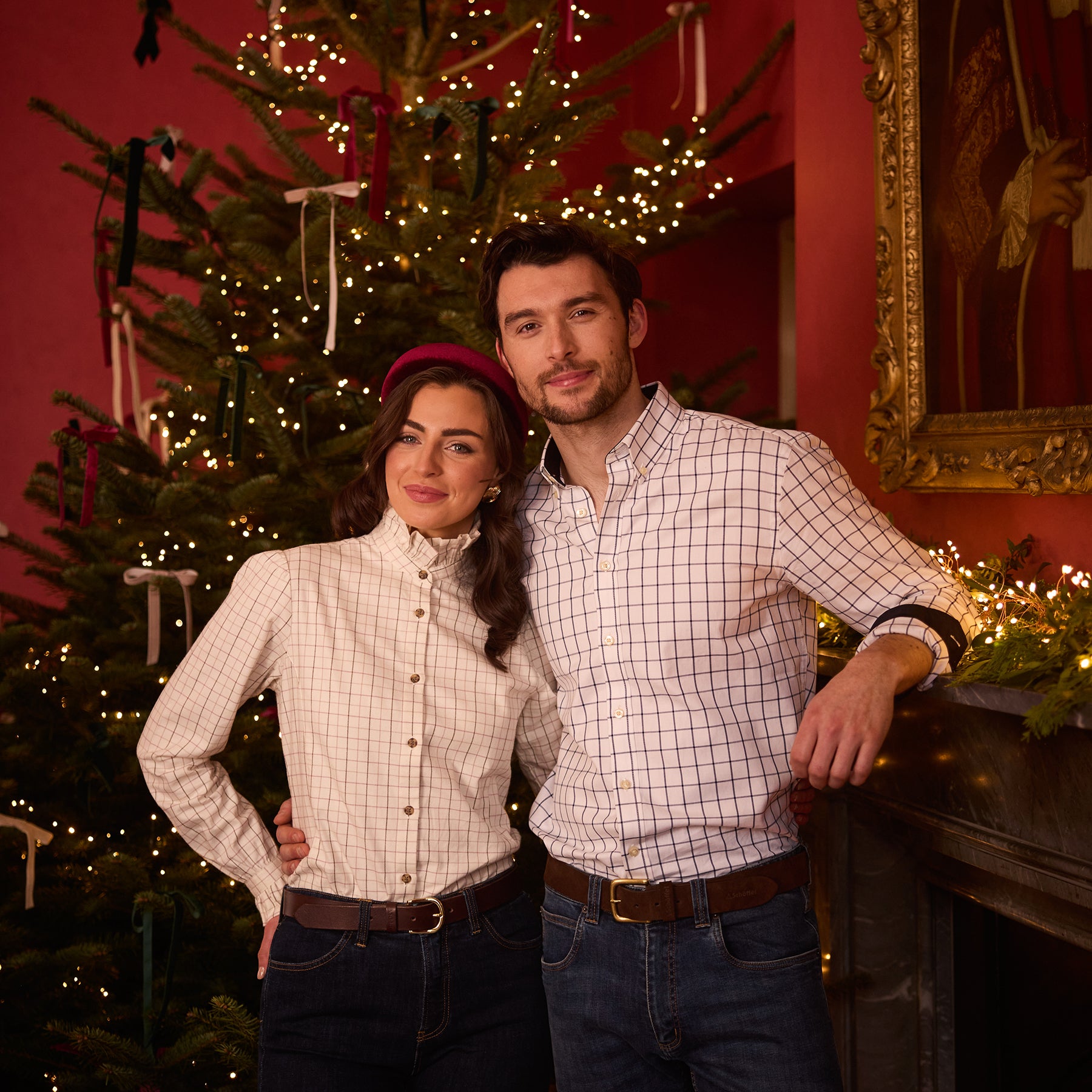 A couple in front of a Christmas tree