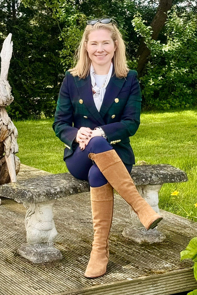 Bobby Hayler-Wright sat in a garden wearing Holland Cooper and Fairfax & Favor clothing and footwear