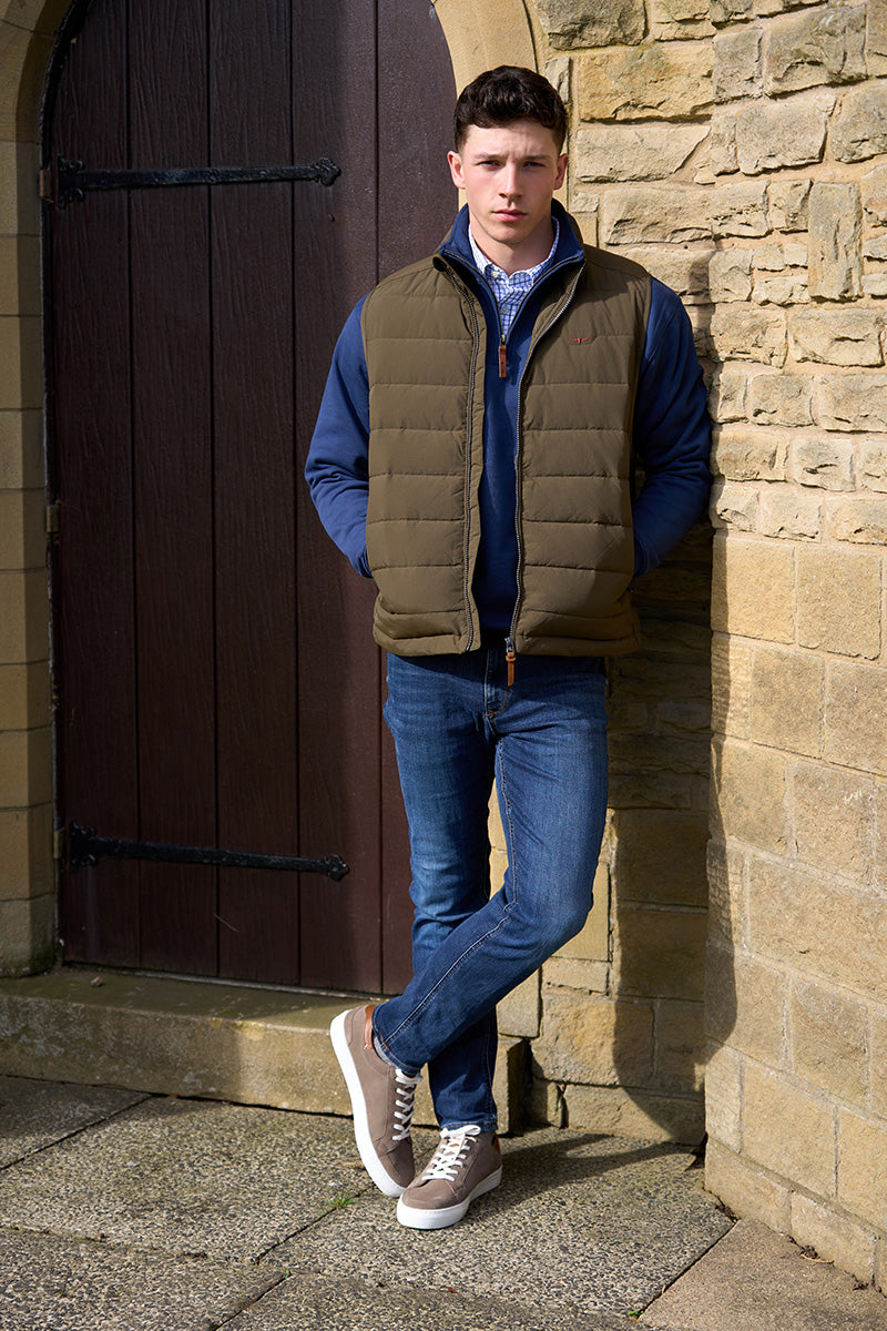 Man leaning against a wall wearing RM Williams clothing