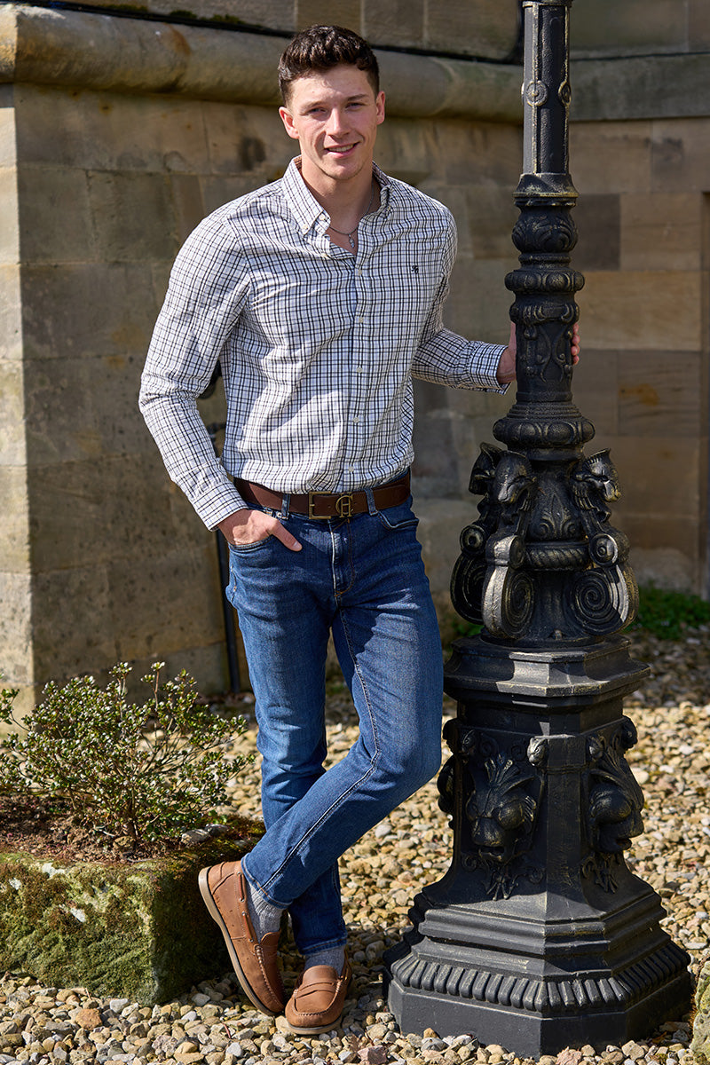 Man stood at a castle wearing Holland Cooper and Schoffel clothing
