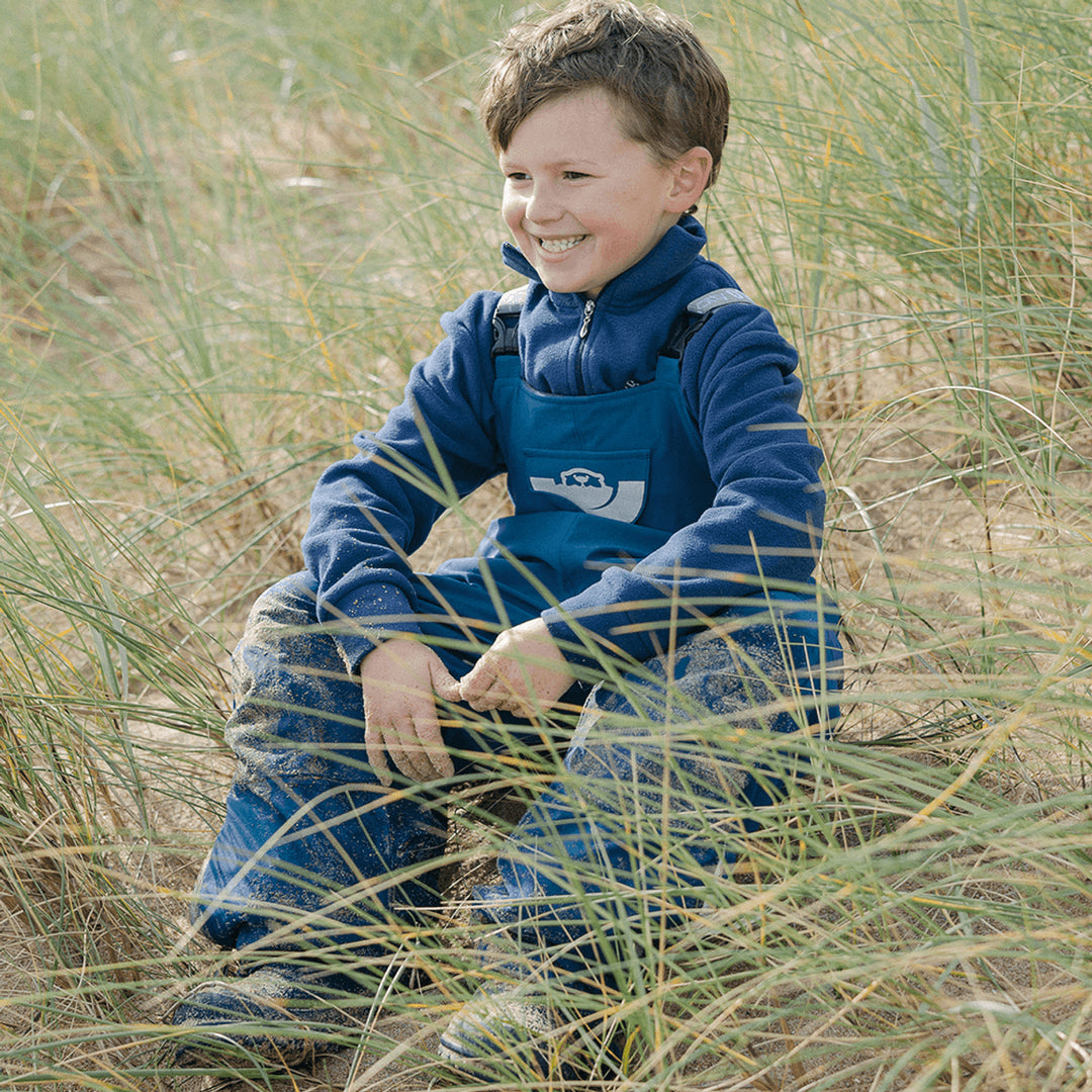 Boy wearing outdoor dungarees