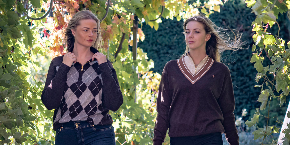 Two women walking through an archway wearing Holland Cooper clothing