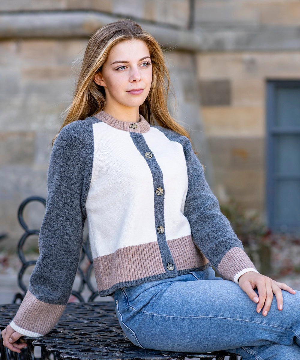 Woman sat on a table wearing new Joules clothing