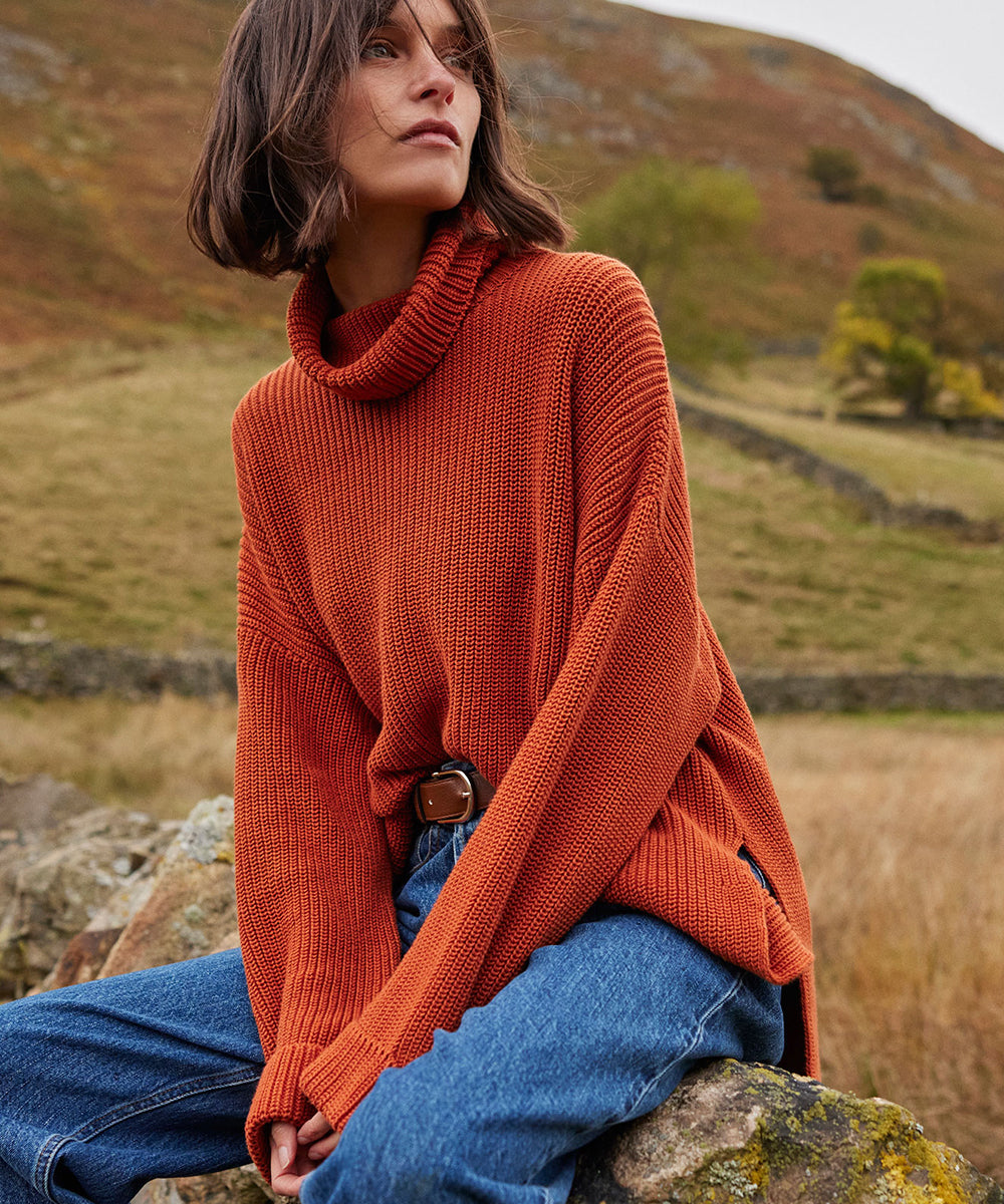 Woman wearing Barbour orange jumper