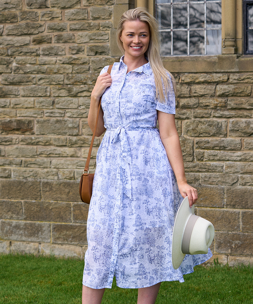 Woman in a dress outside a castle