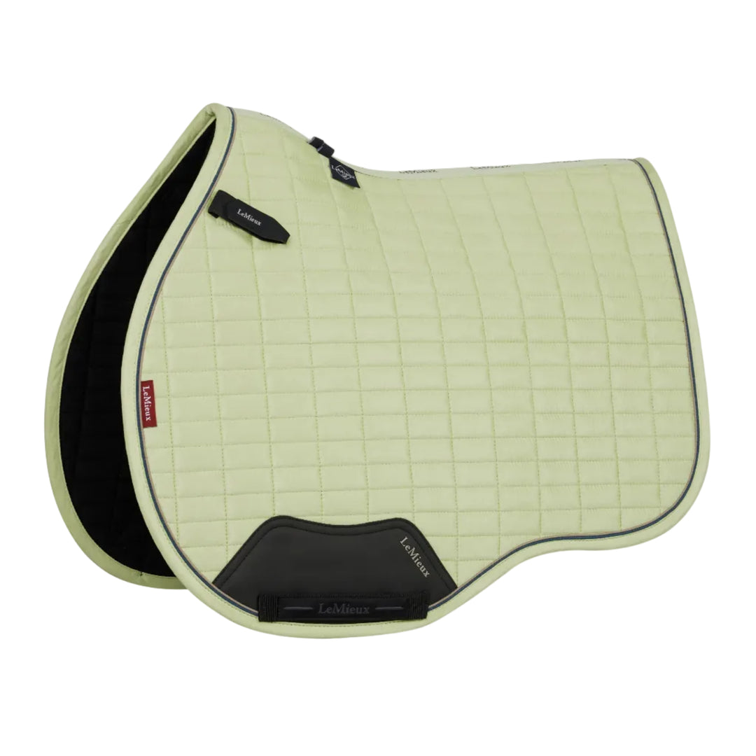 Light green saddle pad with black accents on a white background