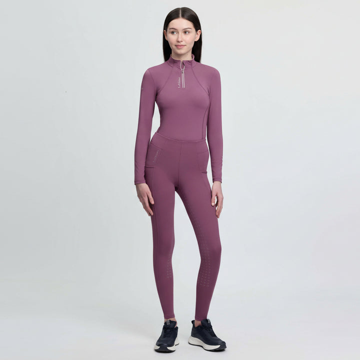 Person wearing a purple athletic equesrian outfit on a white background